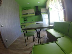 a kitchen with a table and chairs in a room at Apartmens on Khabarovskaya in Kryvyi Rih