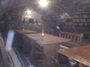 a room with two wooden tables in a cave at Réka Vendéghàz in Tokaj