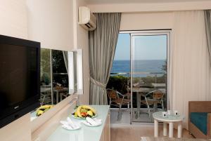 a living room with a view of the ocean at Grand Okan Hotel in Alanya