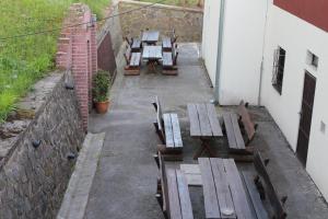 a group of wooden tables and chairs on a patio at Chatisko in Košická Belá