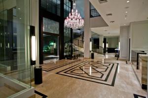 a lobby of a building with a chandelier at Samala Hotel Jakarta Cengkareng in Jakarta