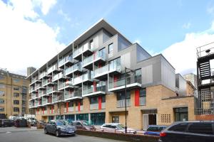 a tall building with cars parked in front of it at Twyne House Apartments in London