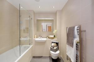 a bathroom with a toilet and a sink and a shower at Twyne House Apartments in London +57 photos