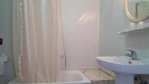 a bathroom with a sink and a shower curtain at Hostal Arli in San Francisco +29 photos