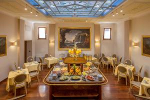 a dining room with a table with food on it at La Residenza in Rome