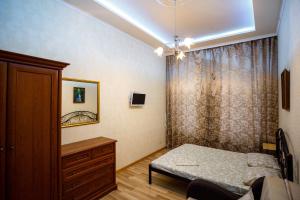リヴィウにあるZamarstynivska apartmentのベッドルーム1室(ベッド1台、ドレッサー、窓付)