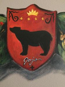 eine Zeichnung eines schwarzen Bären auf einem roten Schild in der Unterkunft Pensiunea JOJO in Băile Herculane