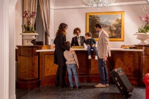 a family standing in front of a desk at La Residenza in Rome