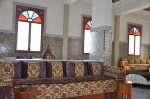a living room with a couch and stained glass windows at Agyad Maroc Appart-Hotel in Agadir