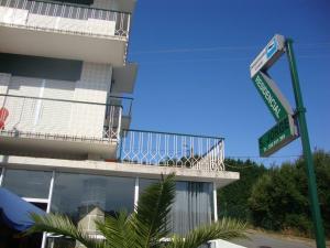 two street signs on a pole in front of a building at Pensão São Jorge in Caldas de São Jorge