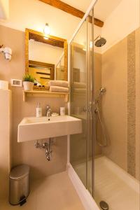 a bathroom with a sink and a shower at Rooms Villa Duketis in Rovinj