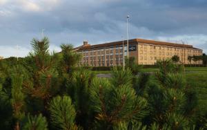 a large building with trees in front of it at The Aberdeen Altens Hotel in Aberdeen