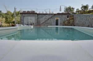a swimming pool with blue water in a house at Podere Delle Fanciulle in Pistoia