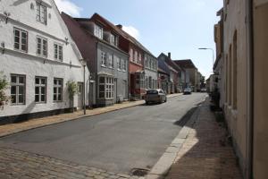 an empty street with a car parked on the road at Apartment 4 in Tønder