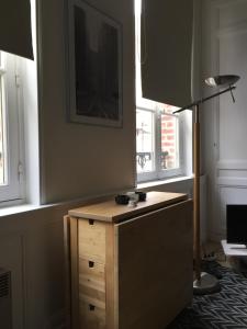 a wooden desk in a room with two windows at Rue Des Lingots Apartment in Honfleur