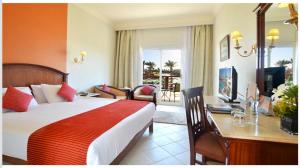 a hotel room with a bed and a desk with a computer at Concorde El Salam Sharm El Sheikh Sport Hotel in Sharm El Sheikh