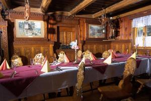 a dining room with a table with purple table cloth at Chalupa Přeslička in Rejvíz