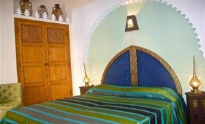 Ein Bett oder Betten in einem Zimmer der Unterkunft Riad Rabahsadia