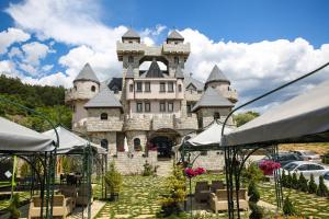 a castle like building with chairs in front of it at Royal Valentina Castle in Ognyanovo