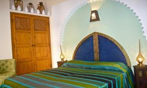 Ein Bett oder Betten in einem Zimmer der Unterkunft Riad Rabahsadia