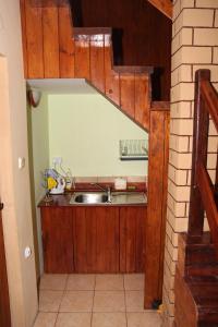 a kitchen with wooden cabinets and a sink at Hlebówka siedlisko w Sudetach in Lubawka