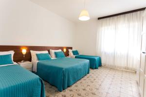 En eller flere senge i et værelse på Hotel Antagos