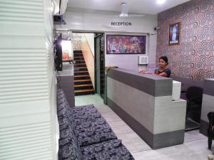 a woman sitting at a counter in a restaurant at Hotel Silver Springs in Ahmedabad