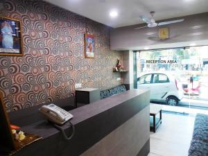 a reception area of a restaurant with a phone at Hotel Silver Springs in Ahmedabad