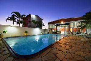 a large swimming pool in front of a building at Manhattan Hotel in Caldas Novas