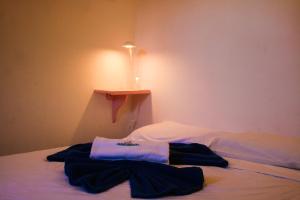 a bed with clothes sitting on top of it at Casa Lagoa in Fortim