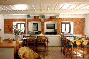 a kitchen and dining room with a table and chairs at Jeleni chata Skladanka in Lučany nad Nisou