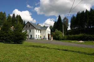 a white house on the side of a road at Jeleni chata Skladanka in Lučany nad Nisou