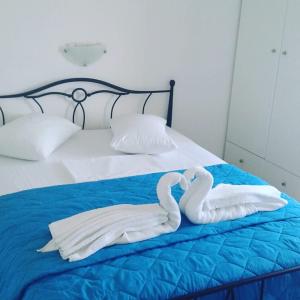 two swans made out of towels on a bed at Vigles in Adamantas