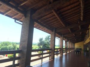 a large wooden pavilion with a wooden floor and large windows at Agriturismo Bassanella in Treviglio