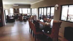 a living room filled with furniture and a large window at Bokmakierie Place in Modimolle