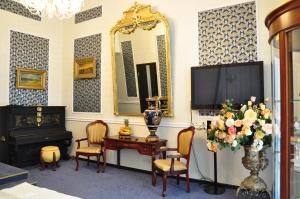 a living room with a television and a table with chairs at Queen Valery Hotel in Odesa