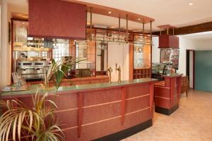 a large kitchen with a counter and a kitchenasteryasteryasteryasteryasteryasteryastery at chambres d'hotes du colvert in Forges-les-Eaux