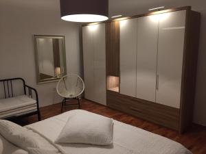 a bedroom with a bed and a dresser and a mirror at Central House Nona in Crikvenica
