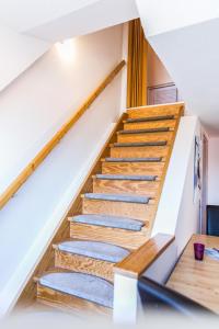 a staircase in a house with wooden treads at Gold Fehmarn in Fehmarn