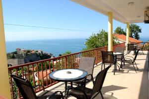 a patio with tables and chairs on a balcony at Guest House Smajlaga in Ulcinj