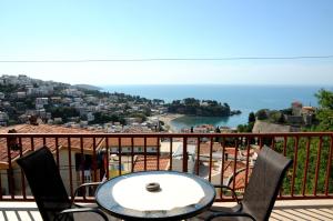 a table on a balcony with a view of the ocean at Guest House Smajlaga in Ulcinj