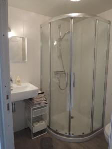 a bathroom with a shower and a sink at La Quincaillerie in Audierne