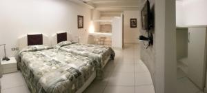 a bedroom with two beds and a flat screen tv at Hotel Residence Germaneto in Catanzaro