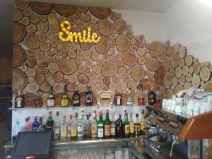 a bar with a bunch of bottles of alcohol at Camping Castillo de Loarre in Loarre