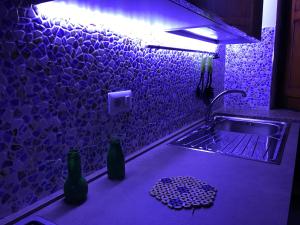 a kitchen with a sink and two bottles on a counter at Casa Bianca Rais Gerbi in Finale