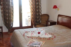 a hotel room with a bed with two towels on it at Residence Hotel Torresilvana in Vieste