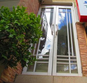 a door to a window with a reflection of the sky at Kandyan Sweet Villa in Kandy