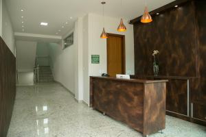 a lobby with a reception desk in a building at Peçanha Grande Hotel in Peçanha