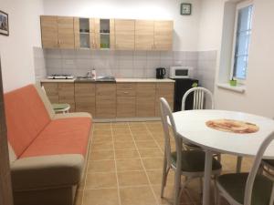 a kitchen with a table and a dining room at Apartmány U Jakuba in Lednice