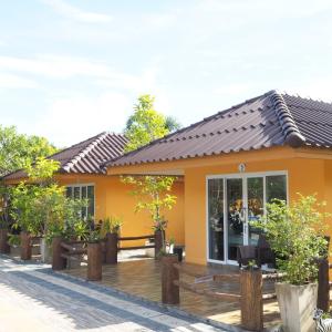 a house with orange walls and a wooden deck at All Times Pool Villa in Ban Ta Khun